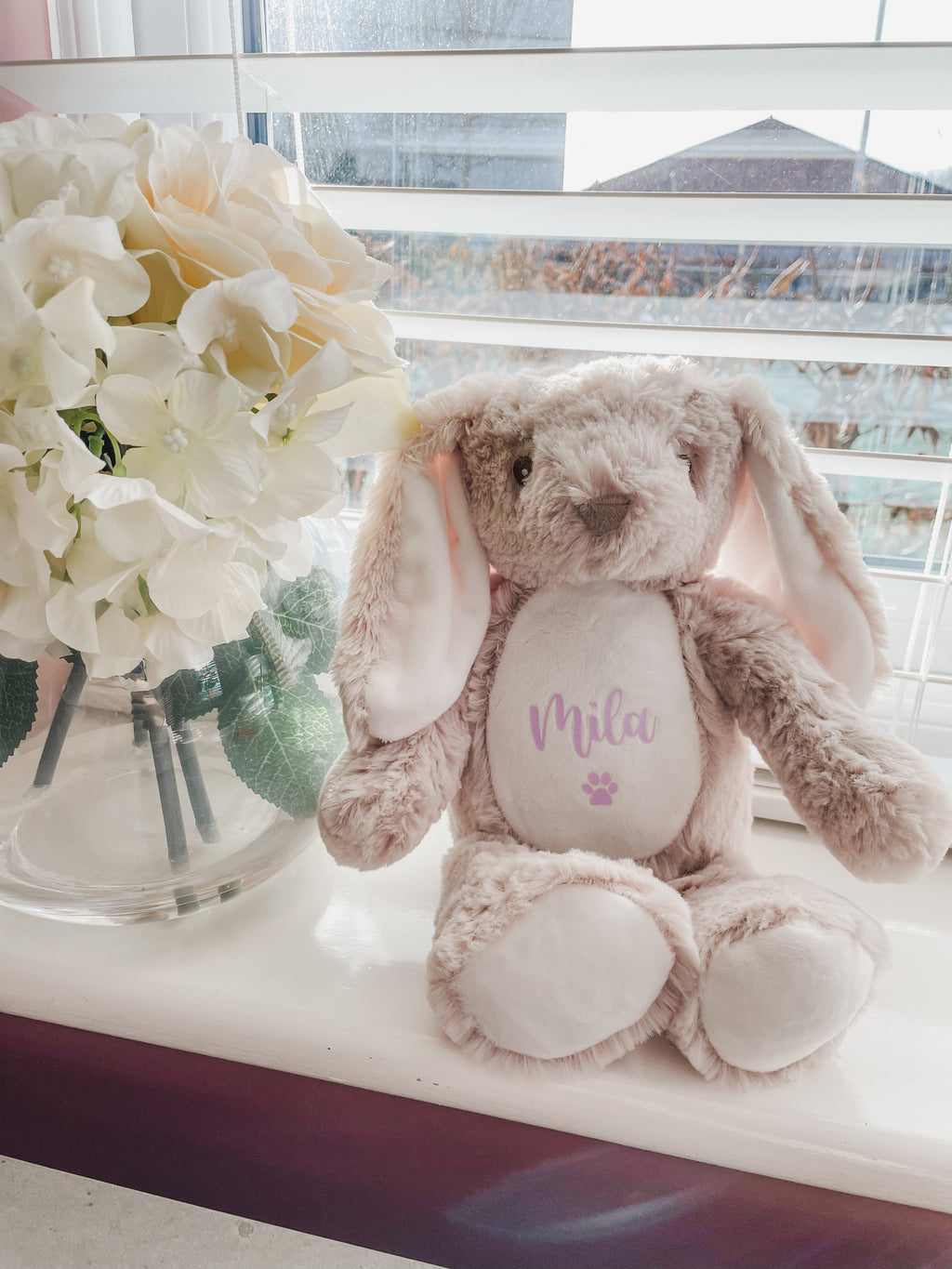 Personalised brown birthday bunny toy for dogs displayed in a cosy home setting.