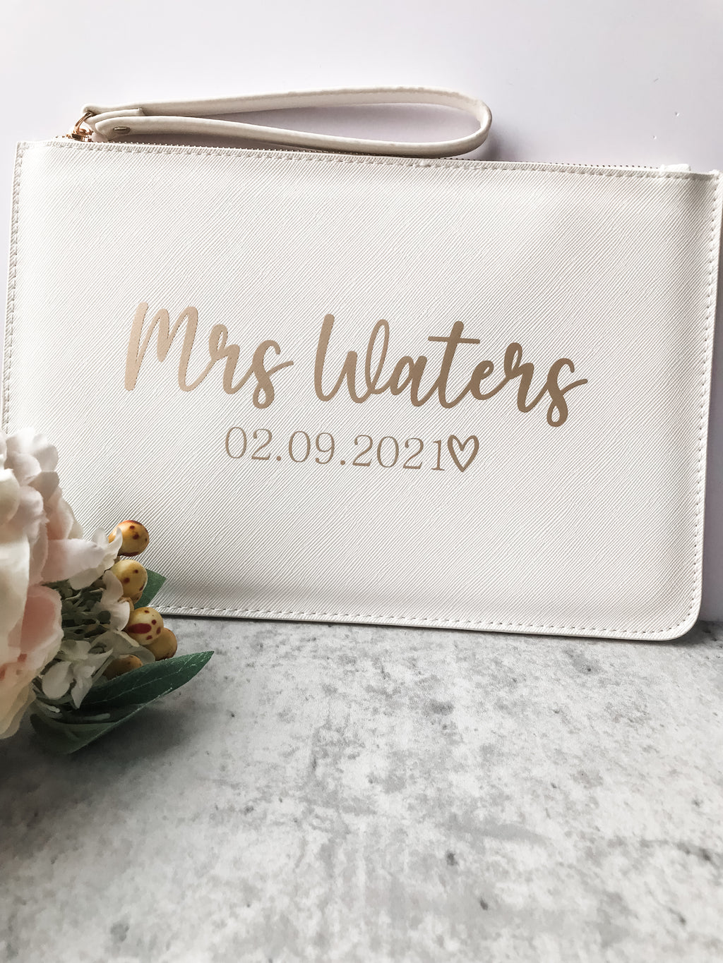 Personalised bride clutch bag with elegant custom surname and wedding date. A timeless bridal accessory for wedding day essentials.