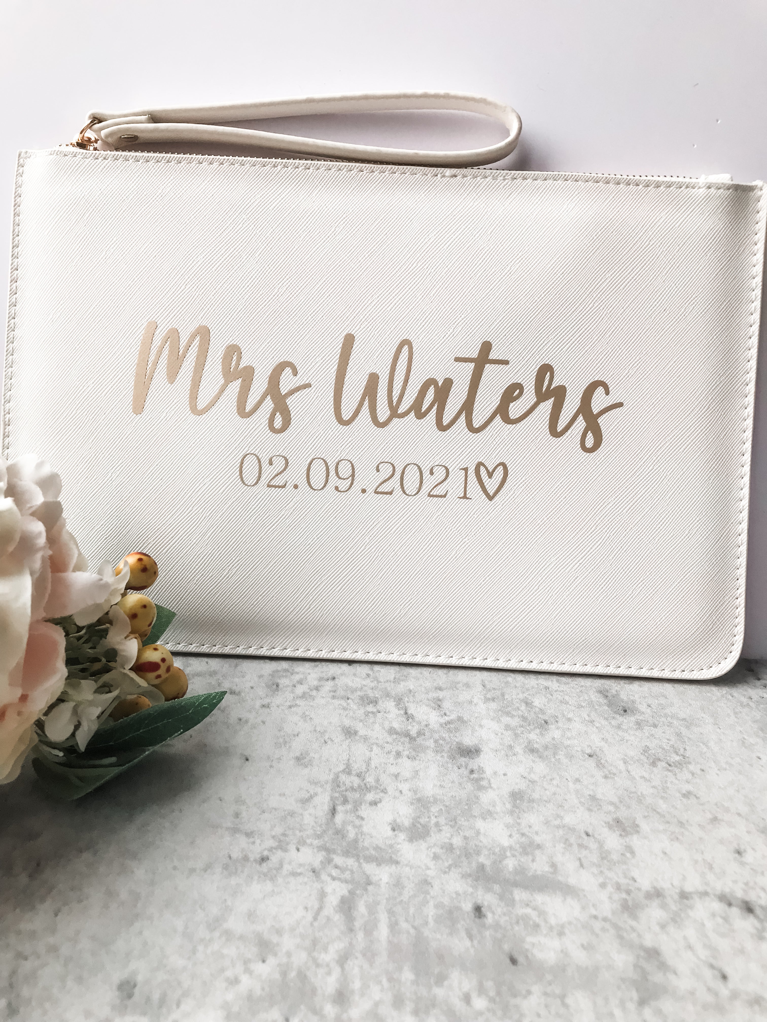 Personalised bride clutch bag with elegant custom surname and wedding date. A timeless bridal accessory for wedding day essentials.