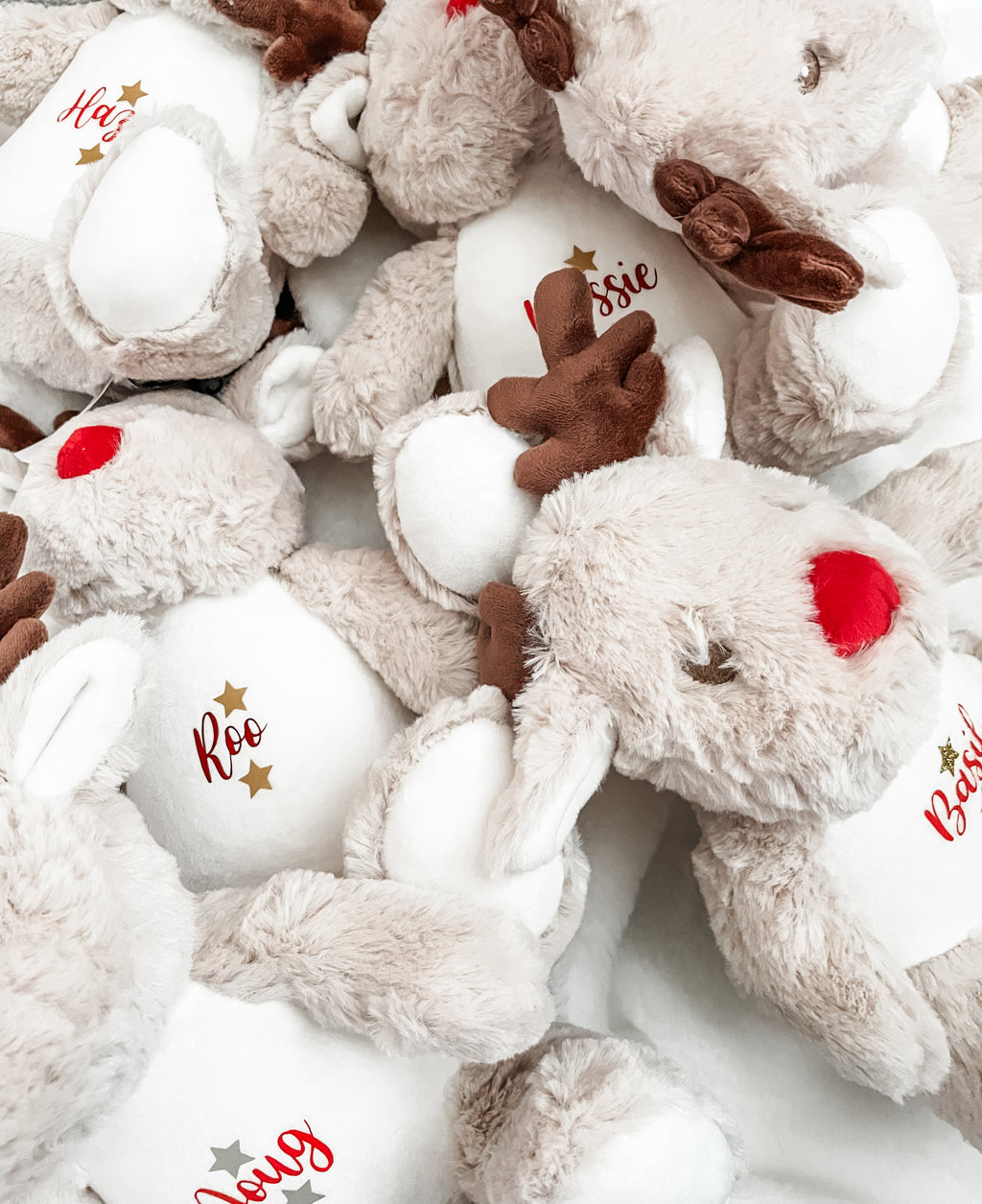 Multiple personalised Christmas reindeer dog toys with custom names. Personalised dog Christmas gifts ready for festive celebrations.