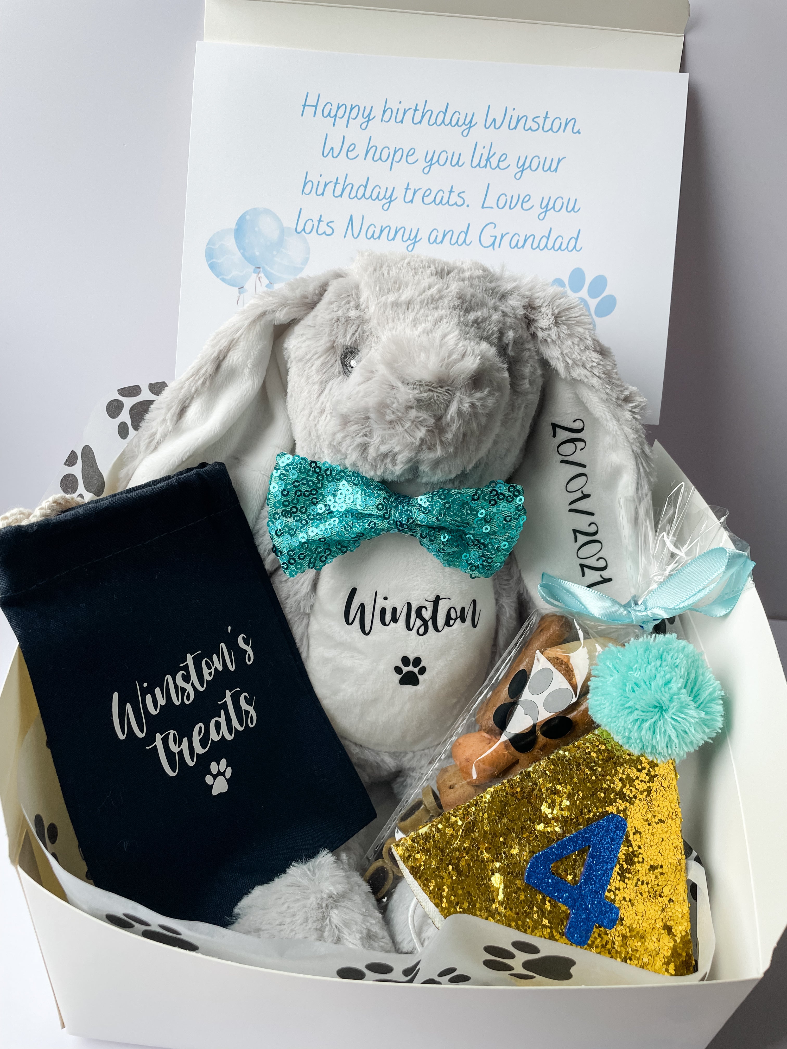 Luxury personalised dog birthday hamper with personalised dog toy, treat bag, treat cone and birthday dog accessories.