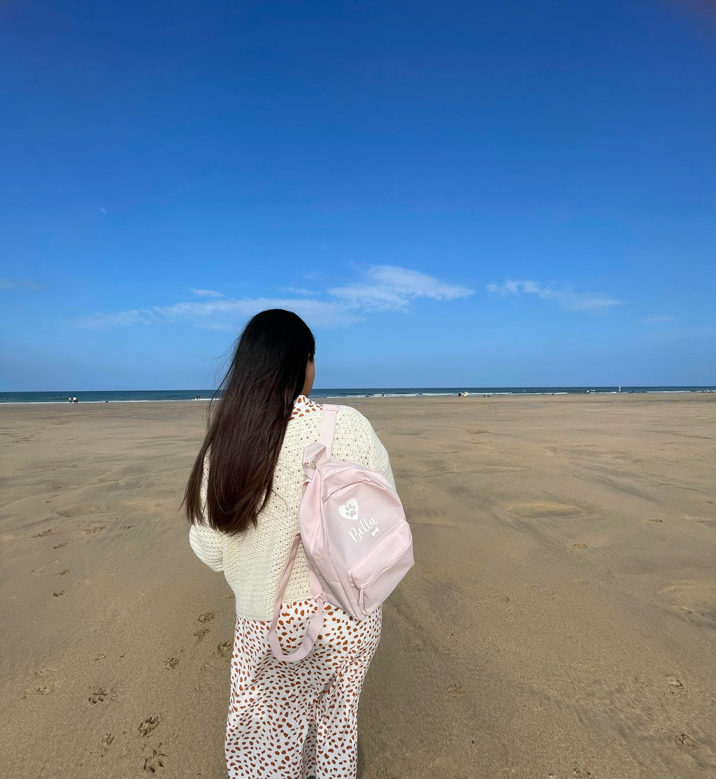 Dog mum wearing personalised dog walking backpack during a day out with their dog. Personalised dog mum gift.