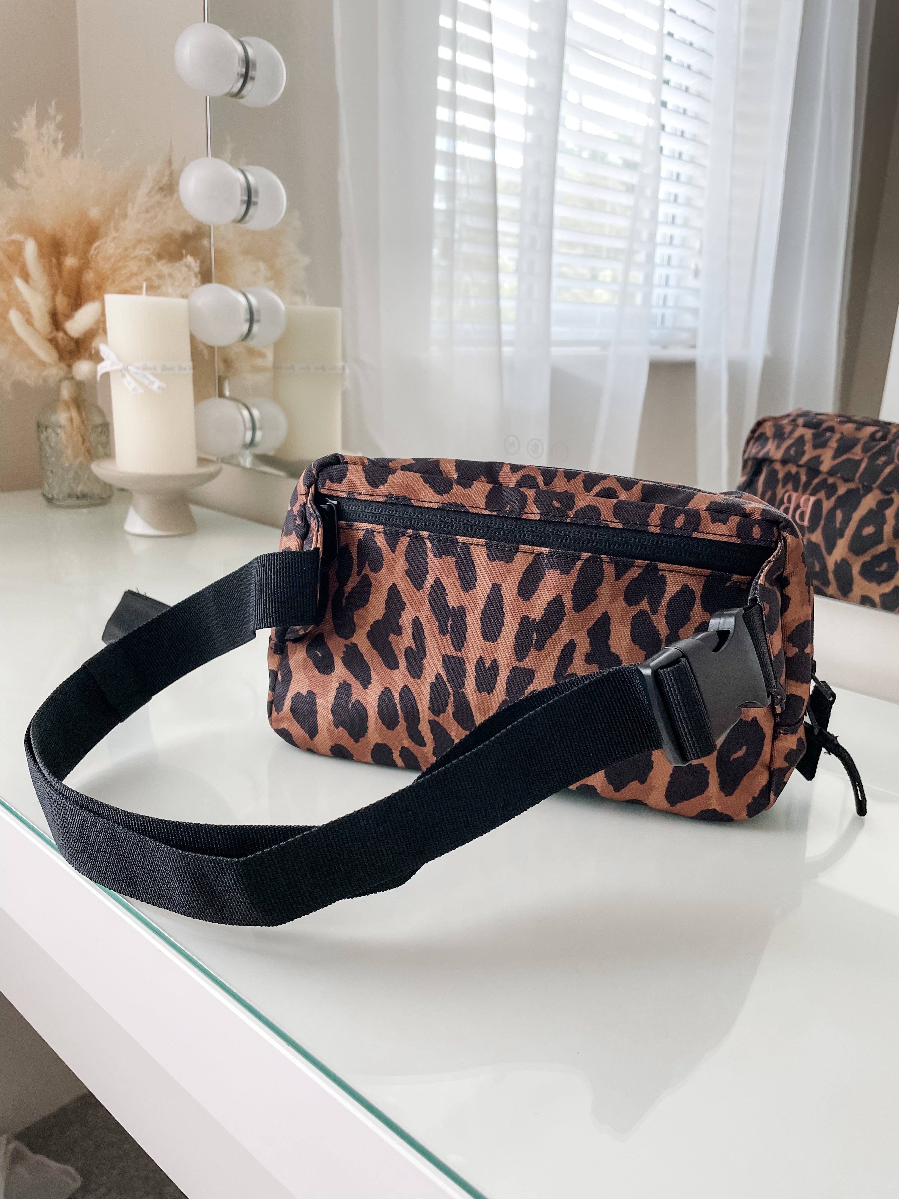 Back view of personalised leopard print crossbody bag showing adjustable strap and zip pocket, practical custom bum bag for everyday wear and dog walking.