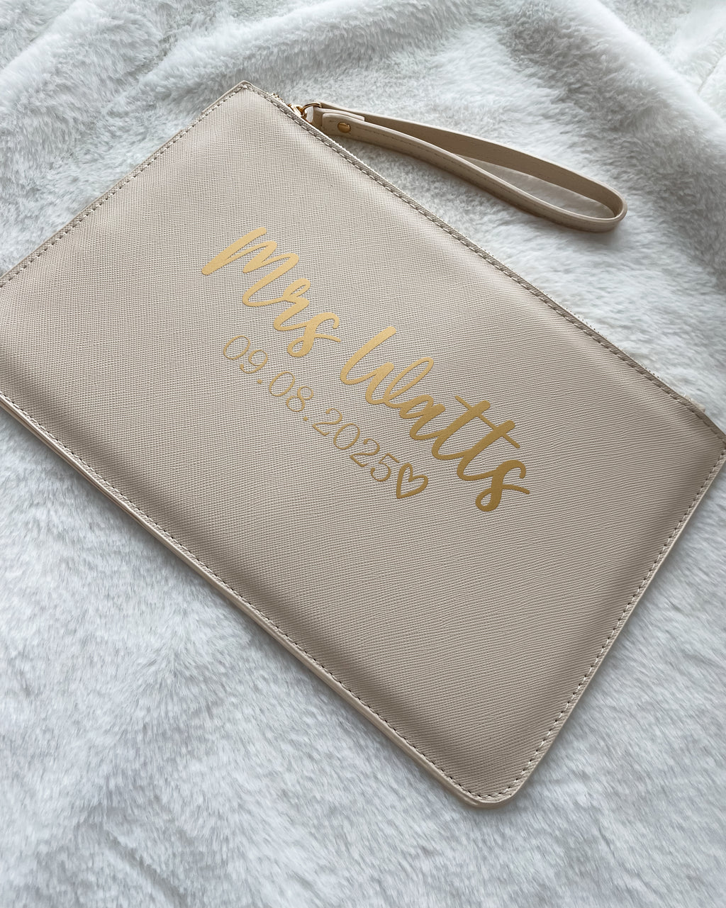 Personalised beige bride clutch bag with custom surname and wedding date. Thoughtful wedding gift and keepsake for the bride.