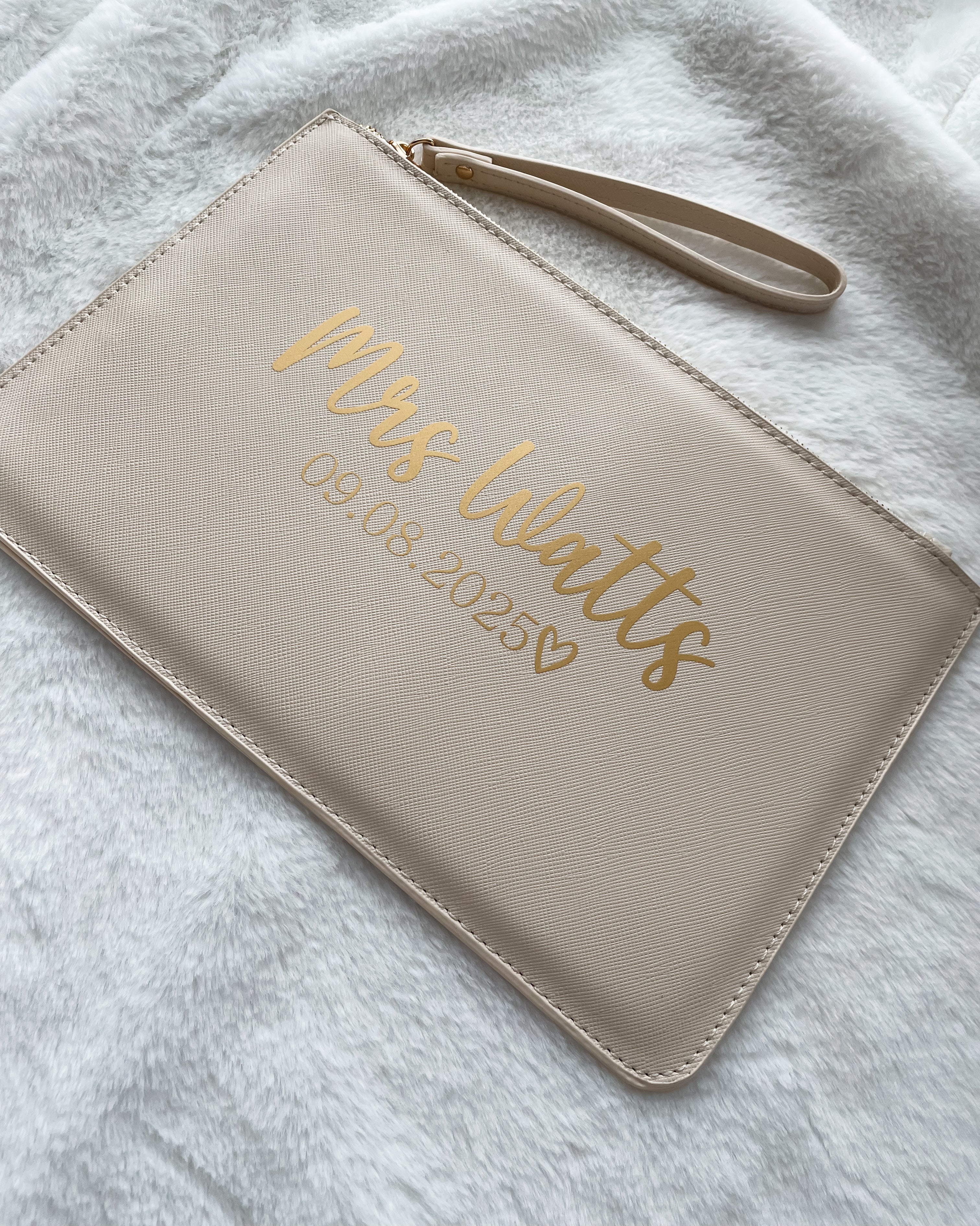 Personalised beige bride clutch bag with custom surname and wedding date. Thoughtful wedding gift and keepsake for the bride.