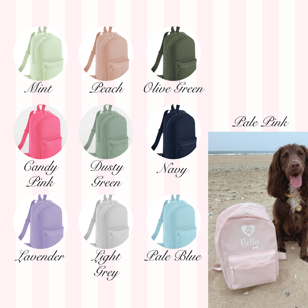 Range of personalised dog backpack colours with custom dog name design, including mint, peach, olive green, candy pink, dusty green, navy, pale pink, lavender, light grey, and pale blue, plus a lifestyle photo of a pink backpack with a Cocker Spaniel on a beach.