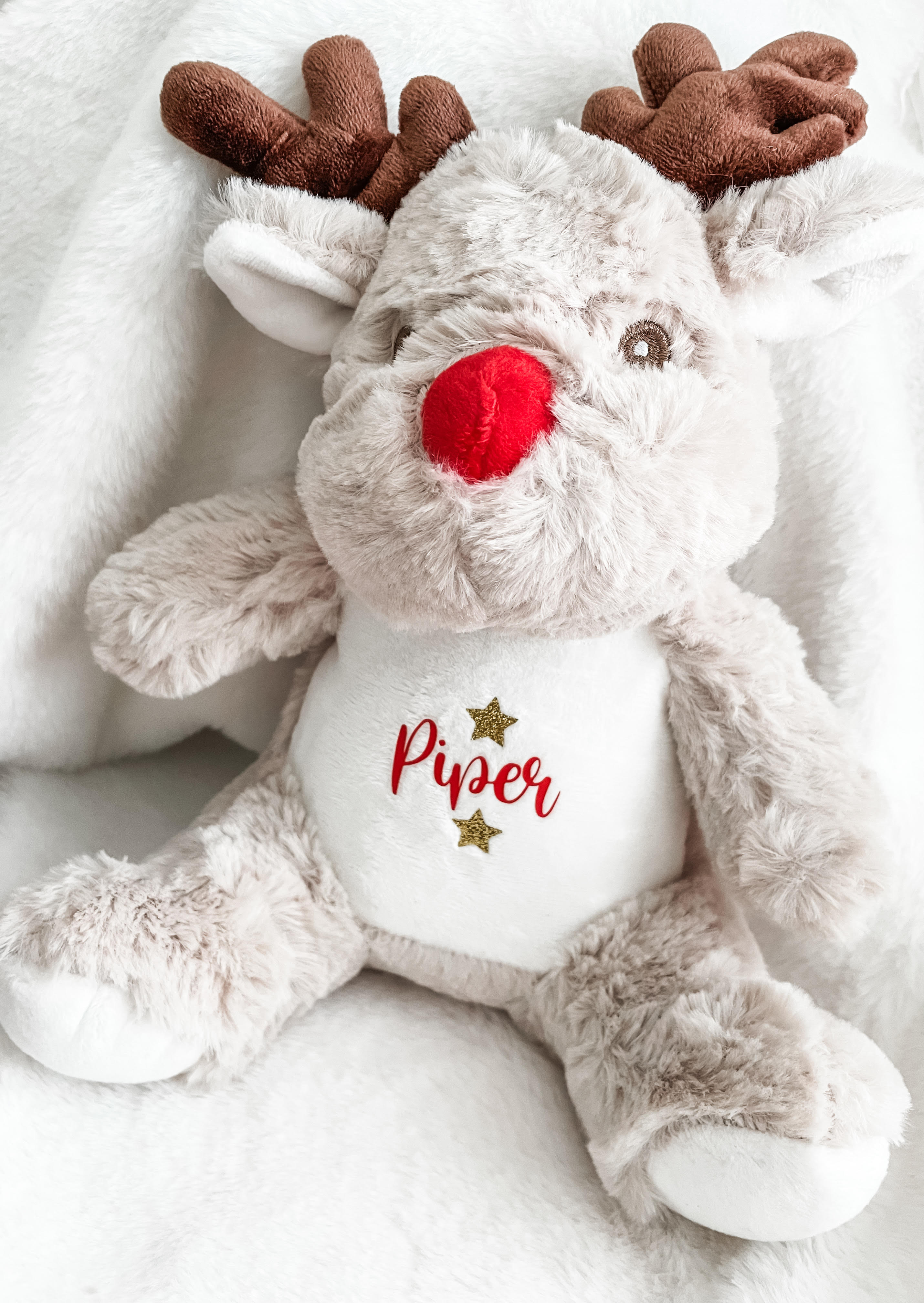 Close-up of personalised Christmas reindeer dog toy with custom name. Festive stocking filler for dogs.