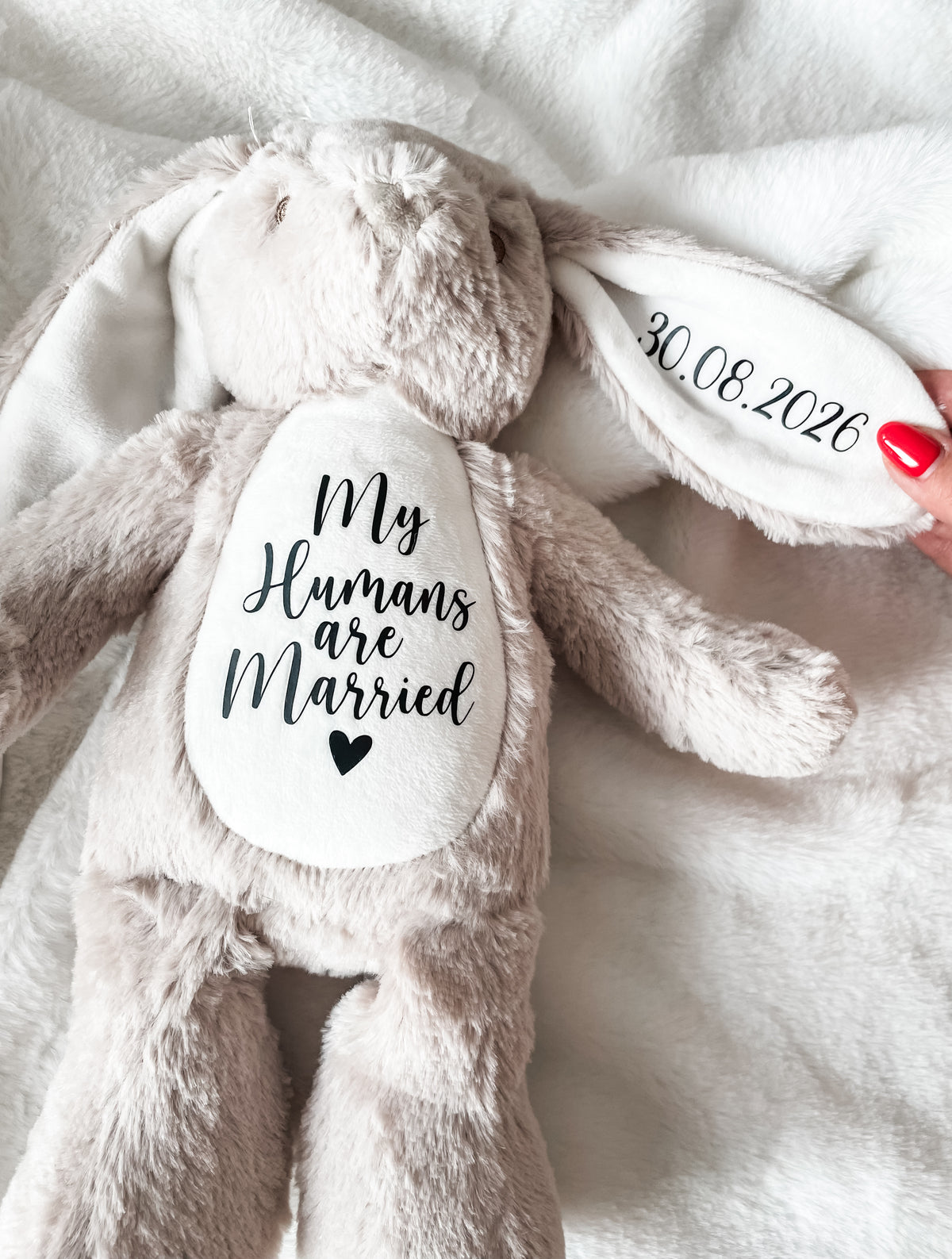Personalised dog wedding toy with the custom text "my humans are married" and the wedding date personalised on a light brown bunny. Custom dog wedding gift.