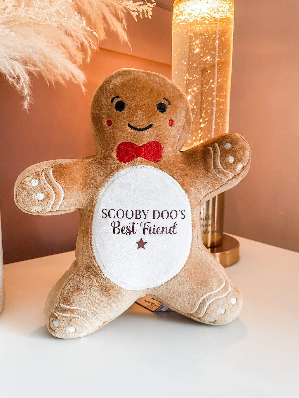 Personalised gingerbread Christmas dog toy personalised with dog's name in a cosy festive home. Personalised Christmas gift for dogs.