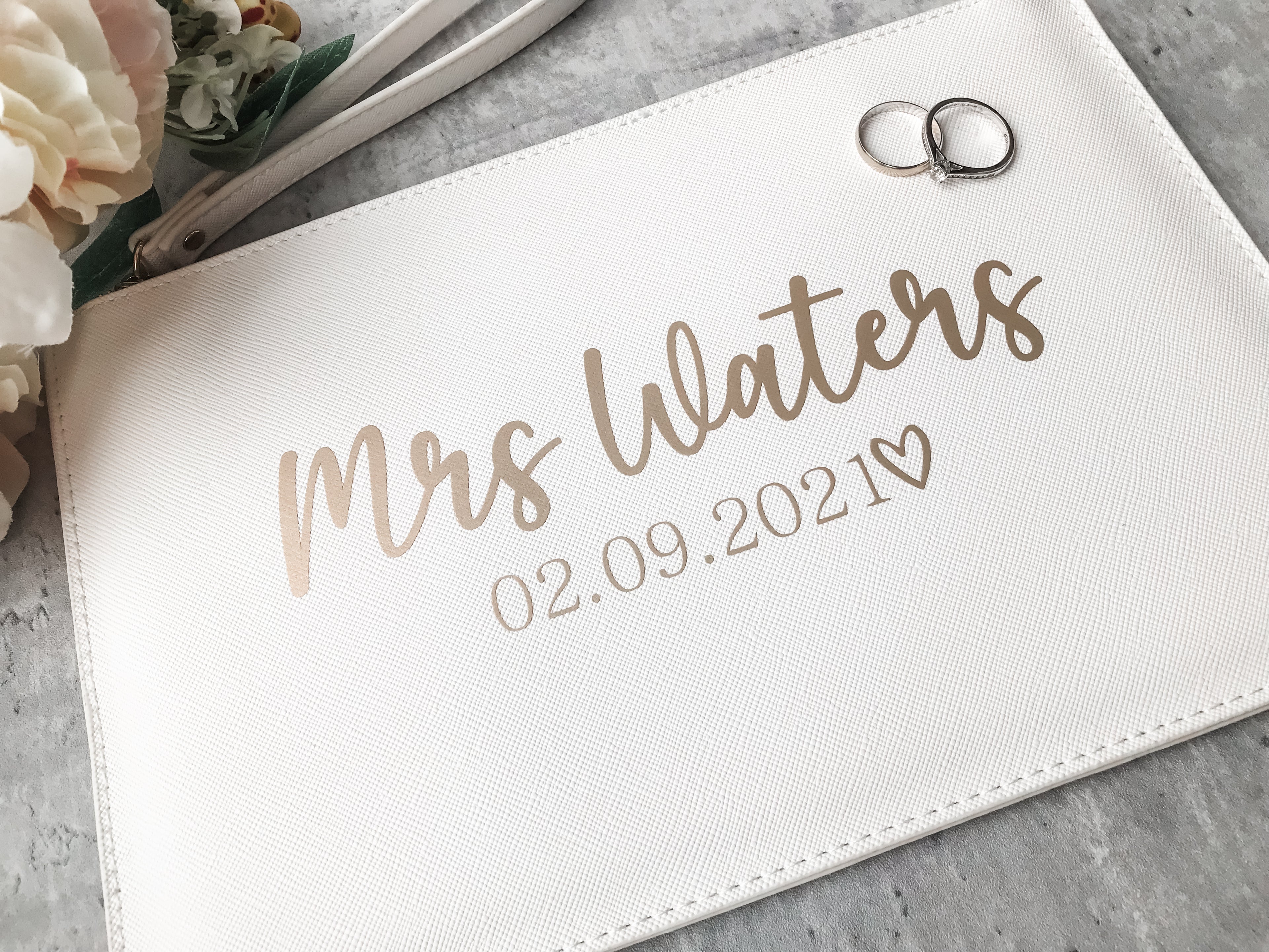 Elegant personalised white bridal clutch bag with custom wedding details. Mrs clutch bag perfect for carrying wedding day essentials.