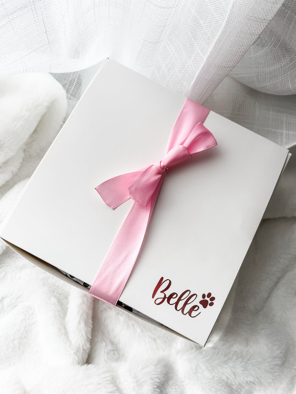 Luxury personalised dog birthday gift box wrapped with satin ribbon and personalised with dog's name.
