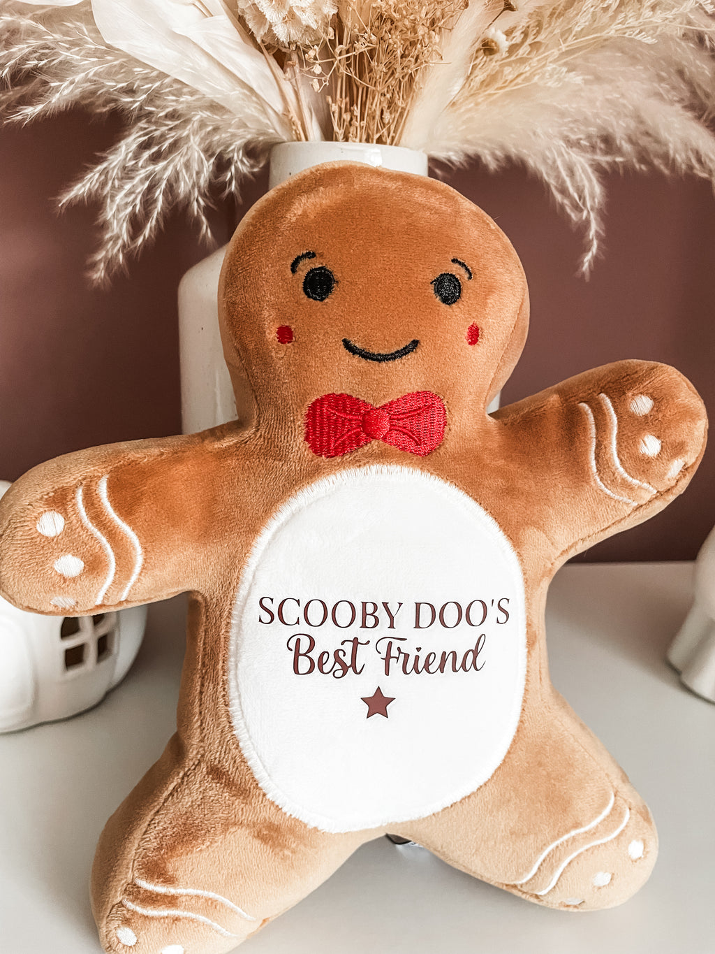 Personalised gingerbread cuddly dog toy in a cosy Christmas setting, festive dog gift and personalised puppy Christmas present.