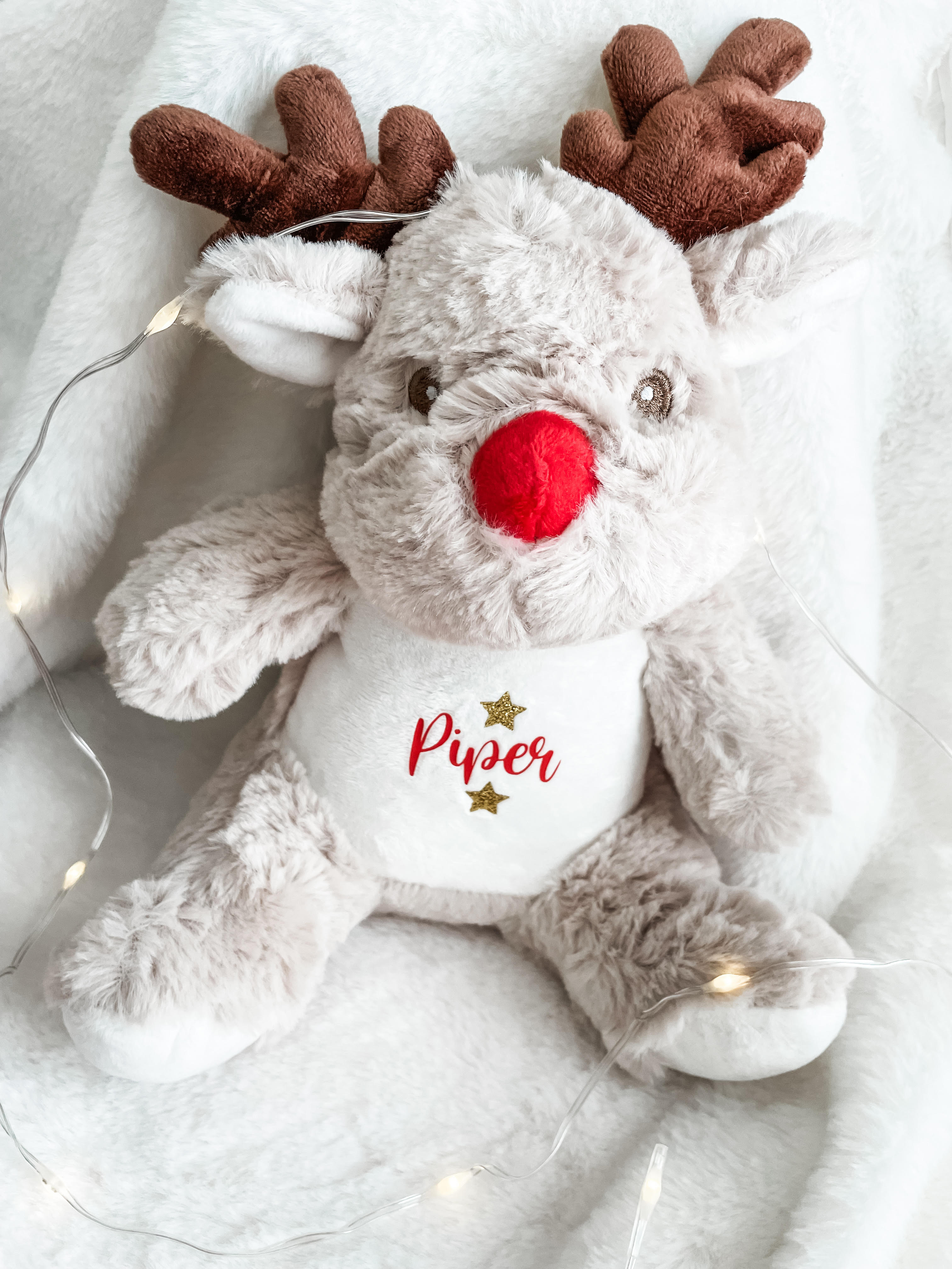 Personalised reindeer dog toy displayed in a festive setting with custom dog name. Christmas gift for dogs.