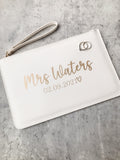 Personalised white bride clutch bag with custom surname and wedding date. A beautiful wedding day keepsake and gift for the bride-to-be.