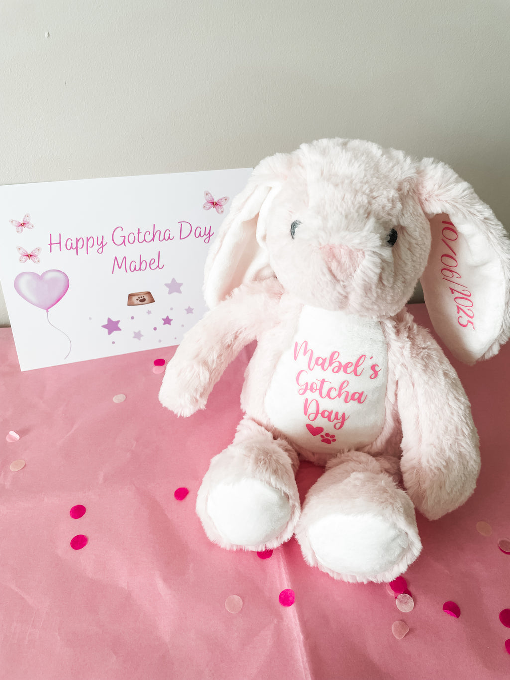 Pink gift wrapped plush bunny with personalised name and gift message card for new puppy celebration.