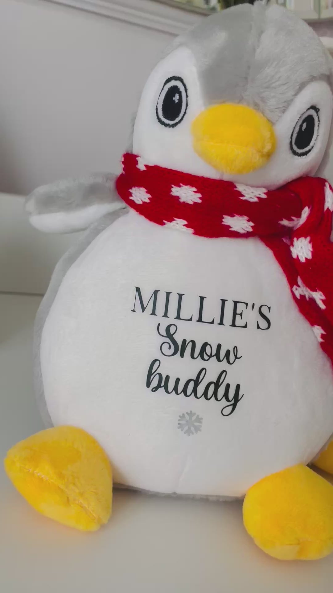 Two personalised penguin Christmas dog toys personalised with dog's names and the words 'Snow Buddy' underneath finished with a silver snowflake symbol on both. A festive Christmas gift for dogs and puppies.