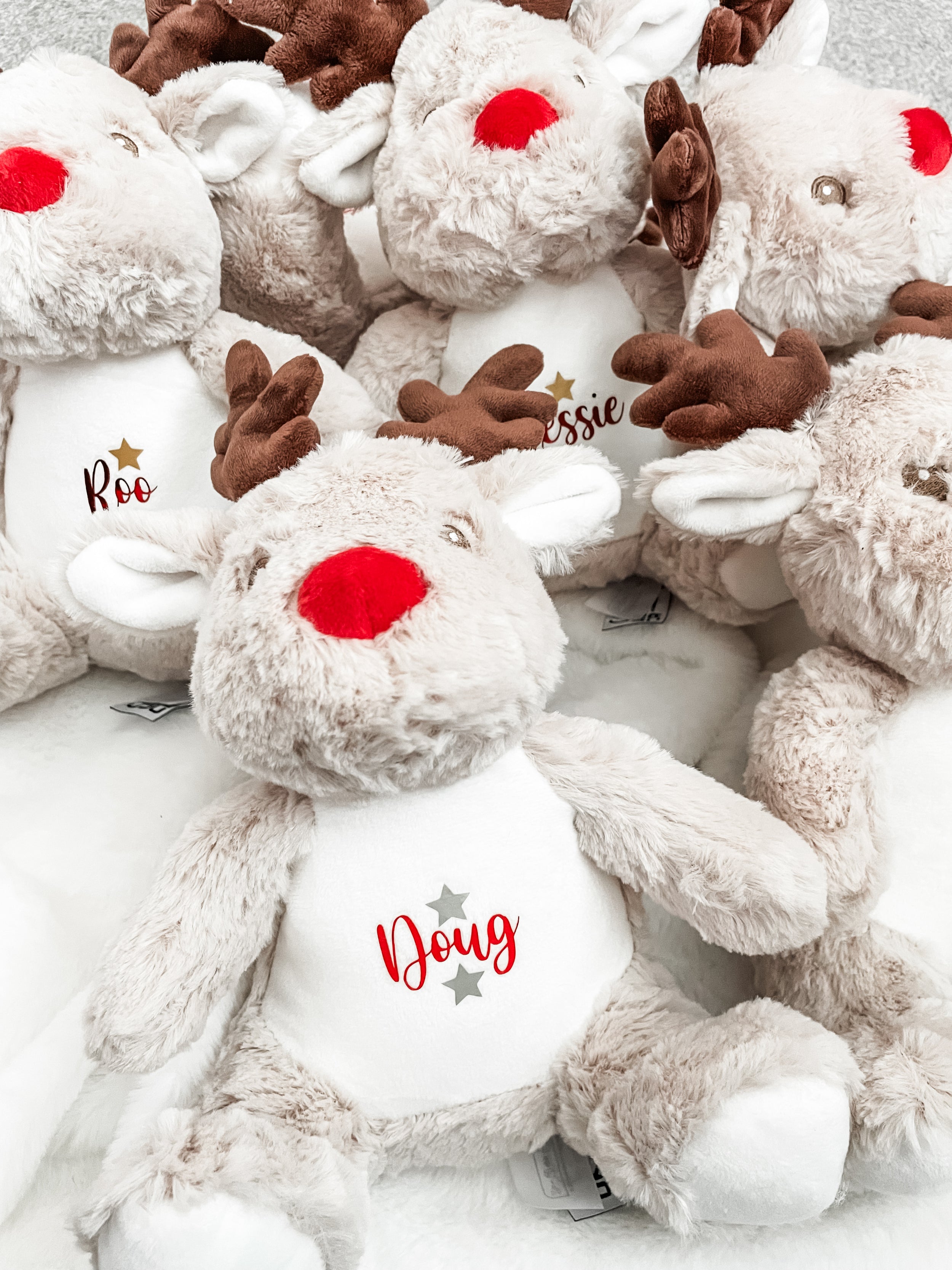 Cocker Spaniel asleep beside personalised Christmas reindeer toy. Soft festive keepsake for dogs.