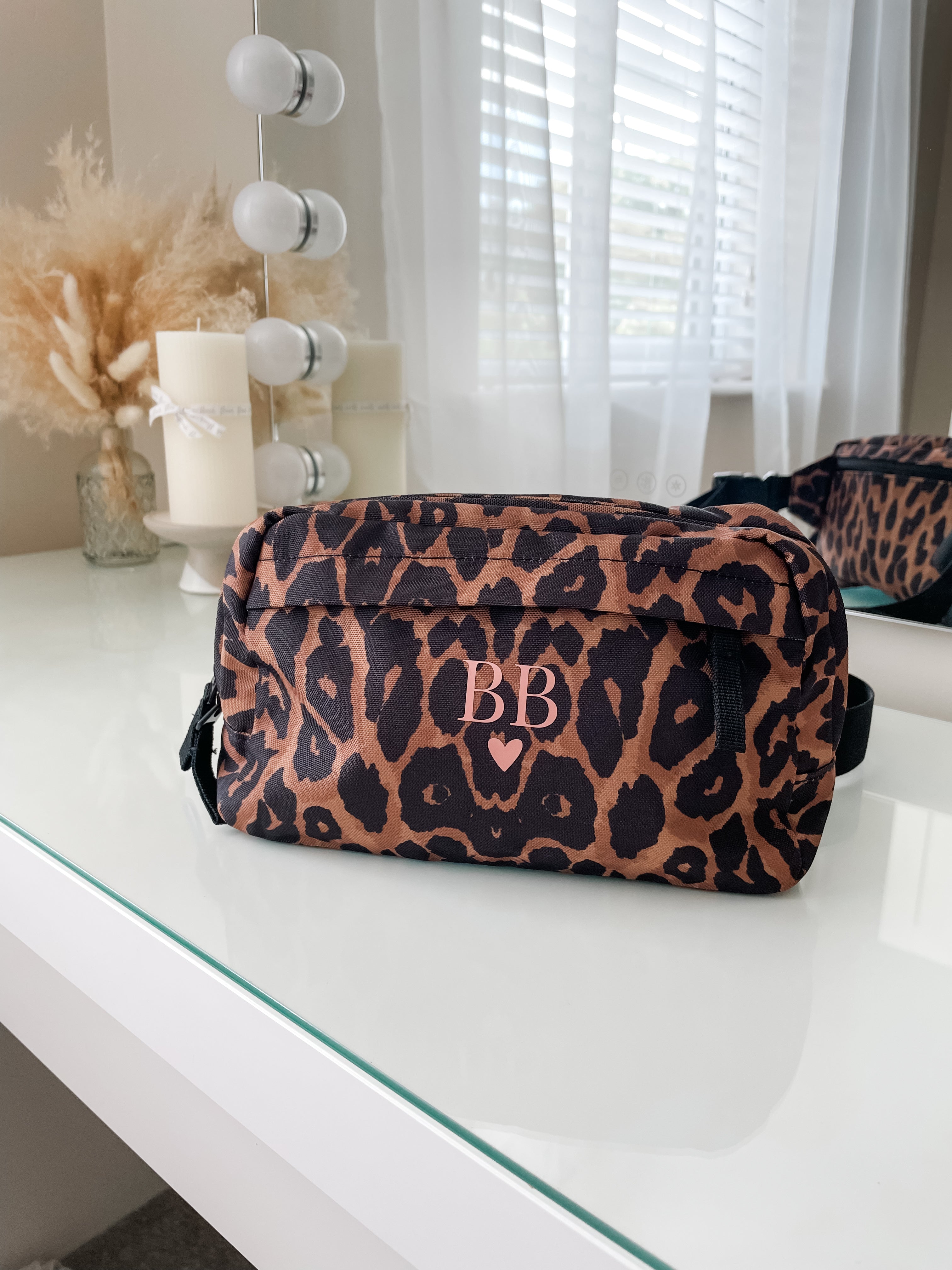 Personalised leopard print bum bag displayed on a dressing table, custom initial crossbody bag, thoughtful gift for her and leopard print lovers.