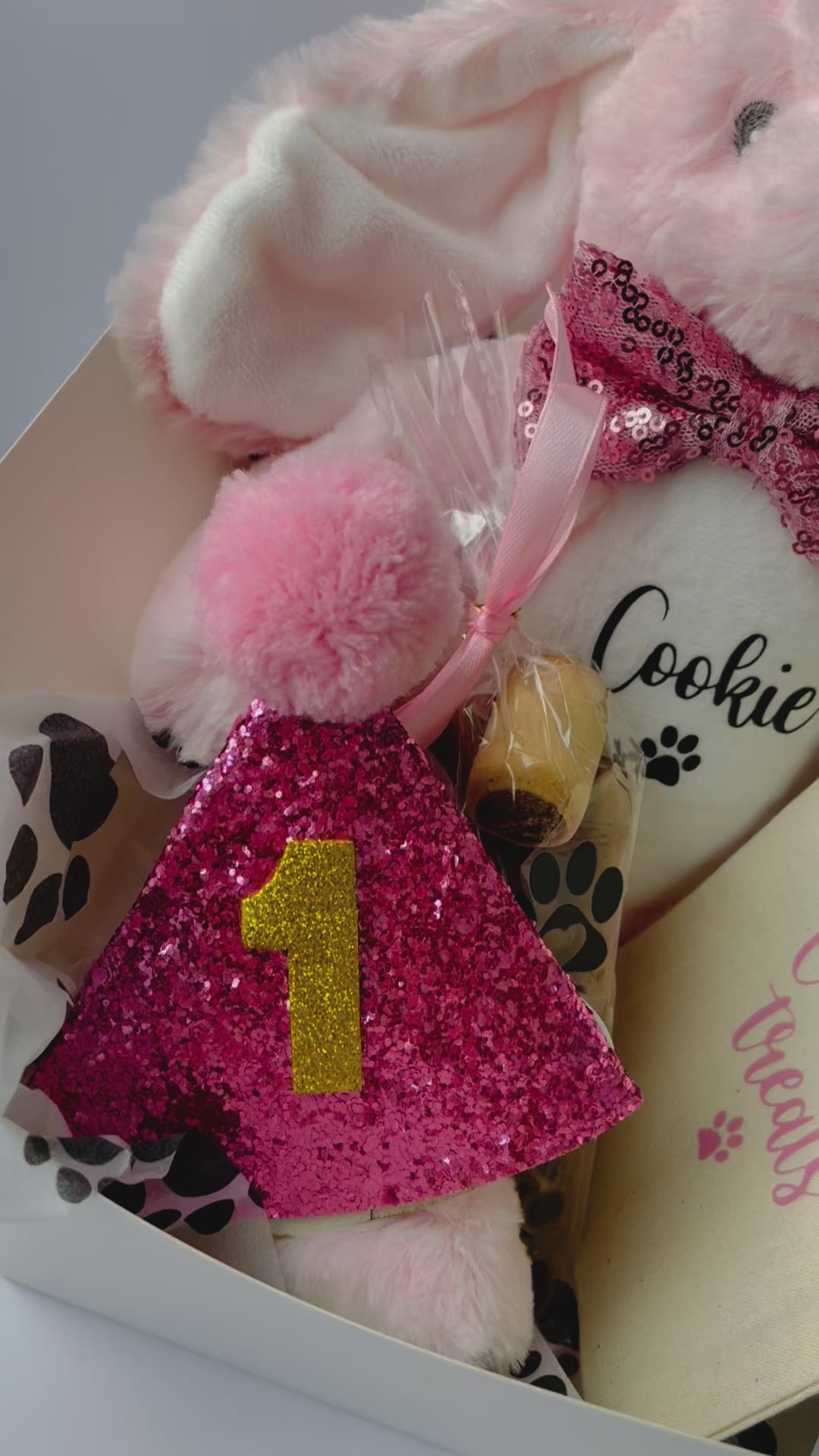 Personalised dog birthday hamper showing personalised bunny toy, treats and luxury gift wrapping.