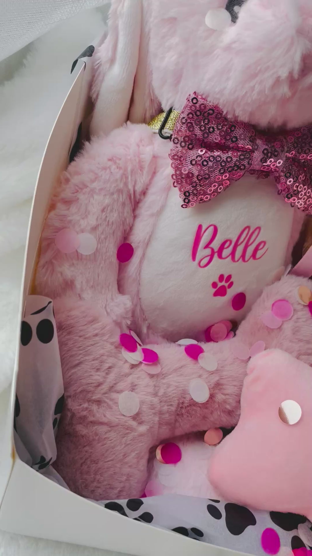 Video showing luxury pink personalised dog birthday hamper gift with soft bunny toy, pink plush toys, birthday treats and gift wrapping.