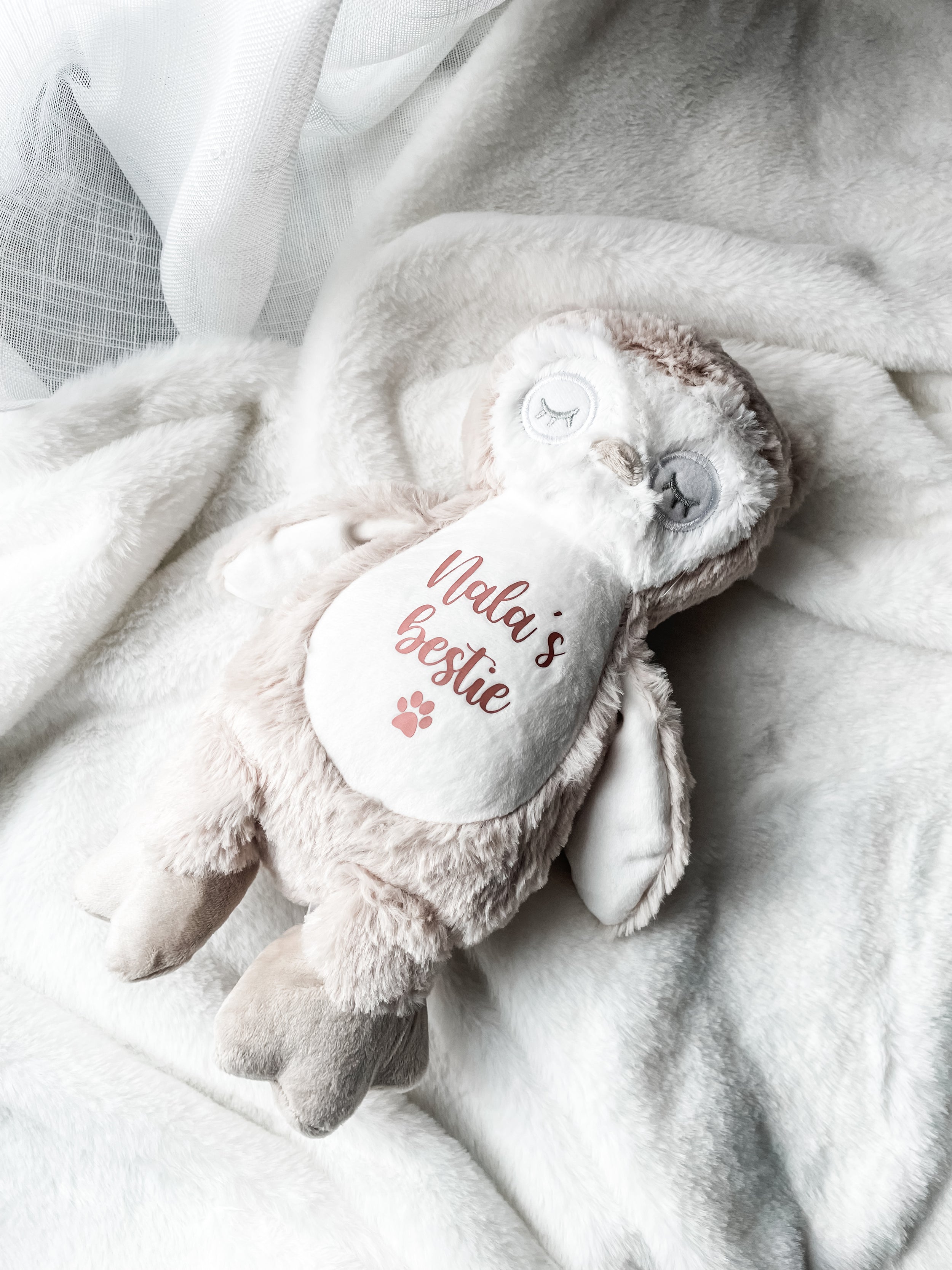 Video of a personalised cat soft owl toy styled in a home setting showing custom name personalisation and paw print symbol in rose gold. Personalised cat birthday gift.