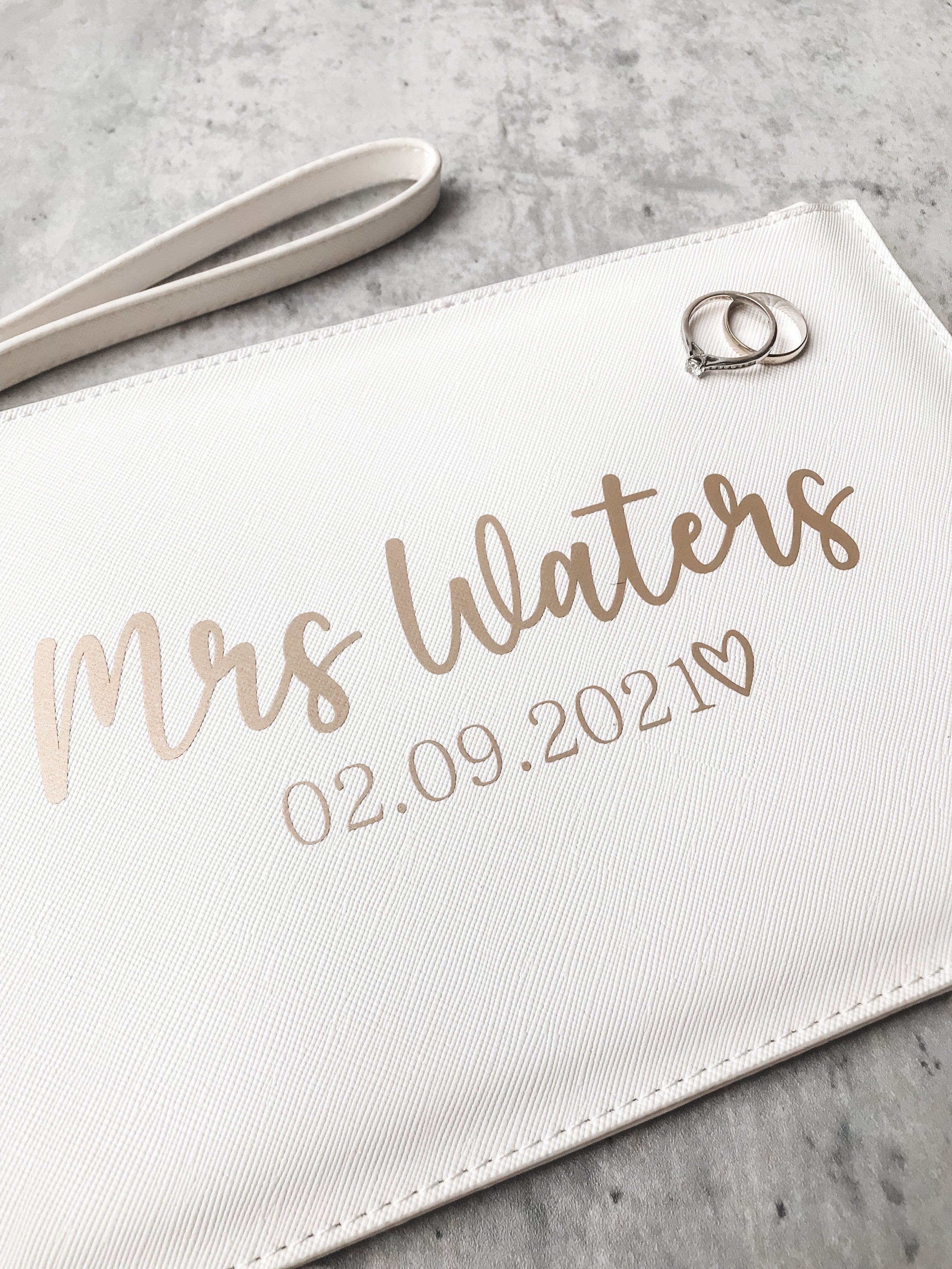 Personalised bride clutch bag featuring custom surname and wedding date. A beautiful wedding morning gift for the bride-to-be.
